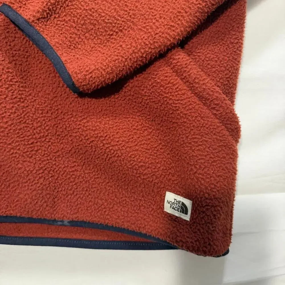 The North Face orange fleece hoodie with navy blue trim, size M